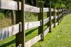 brown wooden fence on green grass field during daytime